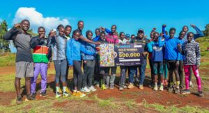 Coach-Elkanah-Rutto-flanked-by-elated-athletes-under-his-tutelage-scaled