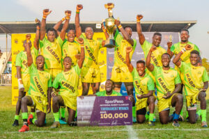 Kabras RFC players lift the Dala 7s trophy after emerging victorious.