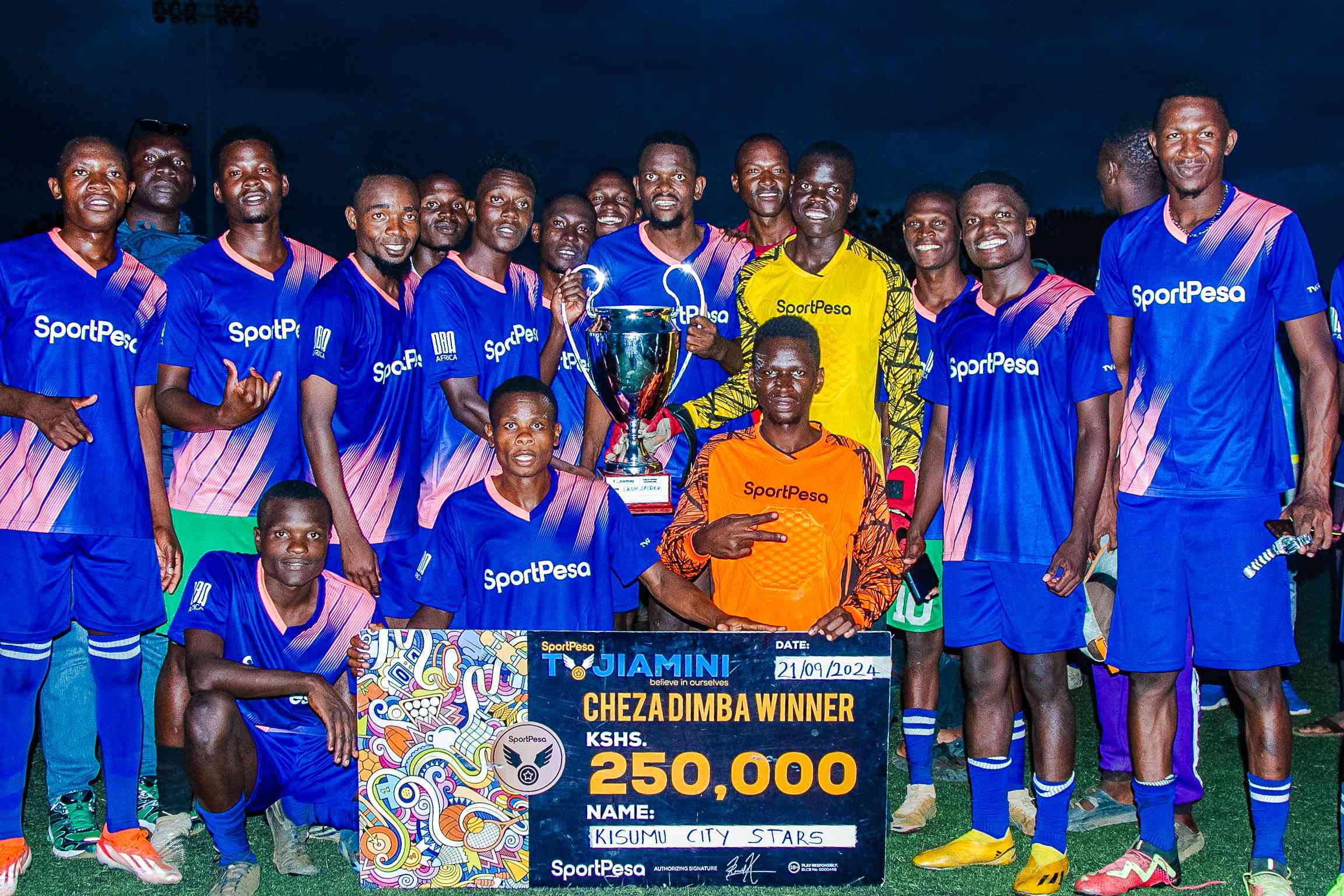 Kisumu City Stars players pose with the trophy after landing a 3-year sponsorship worth Kes 250,000 with Tujiamini.[ROTUNO KWONYIKE WINNIE GOR]